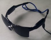 Opaque clip-on sunglasses attached to camera glasses